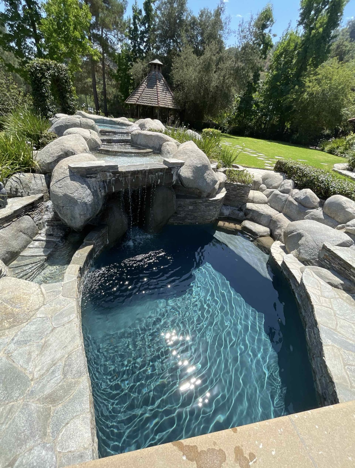 Natural rock waterfall pool with clear water