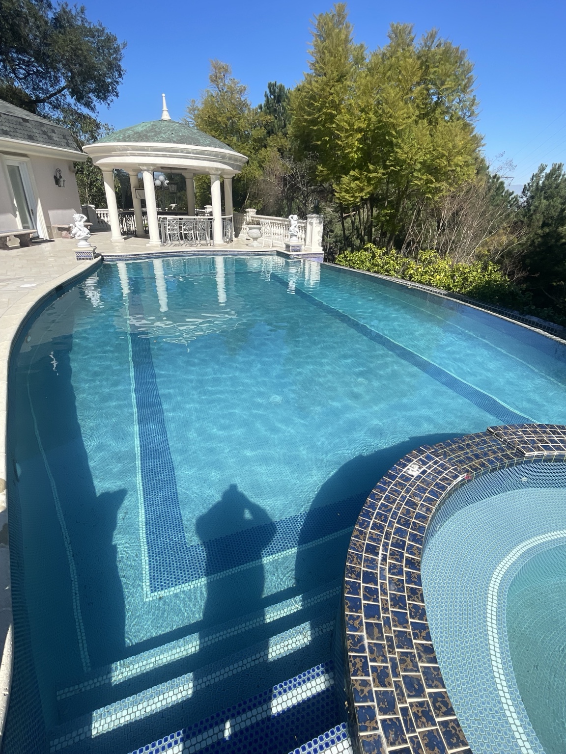 Residential pool with pavilion and blue-tiled spa